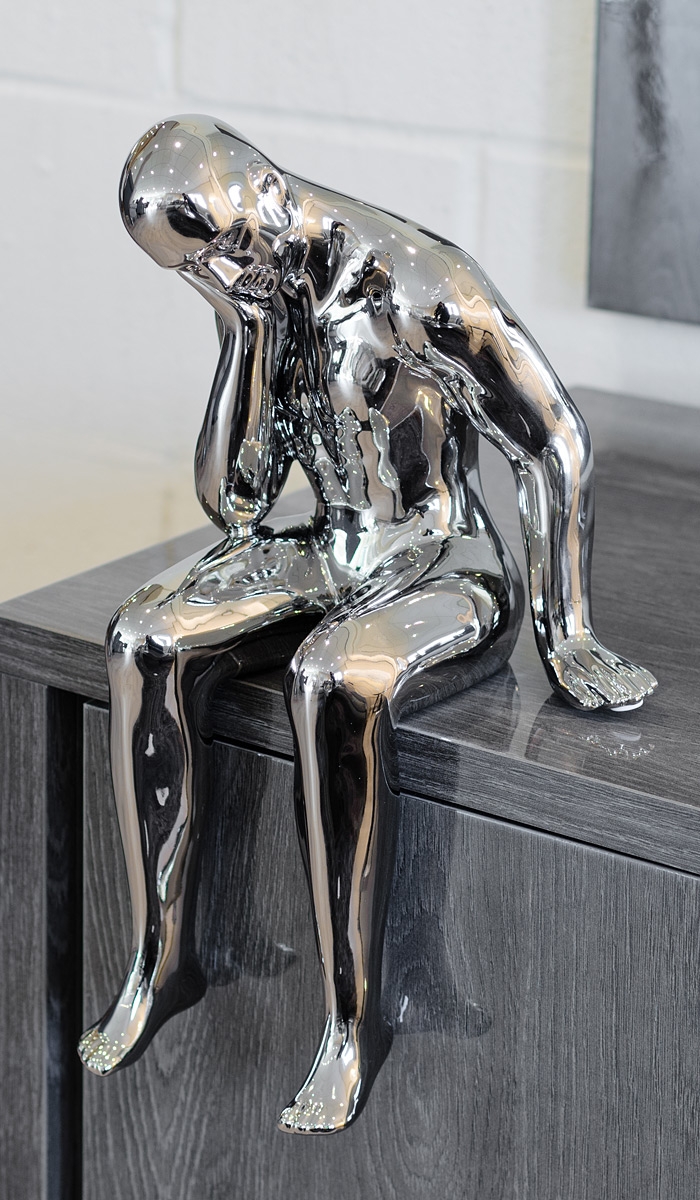 Ceramic thinking man sculpture in our showroom