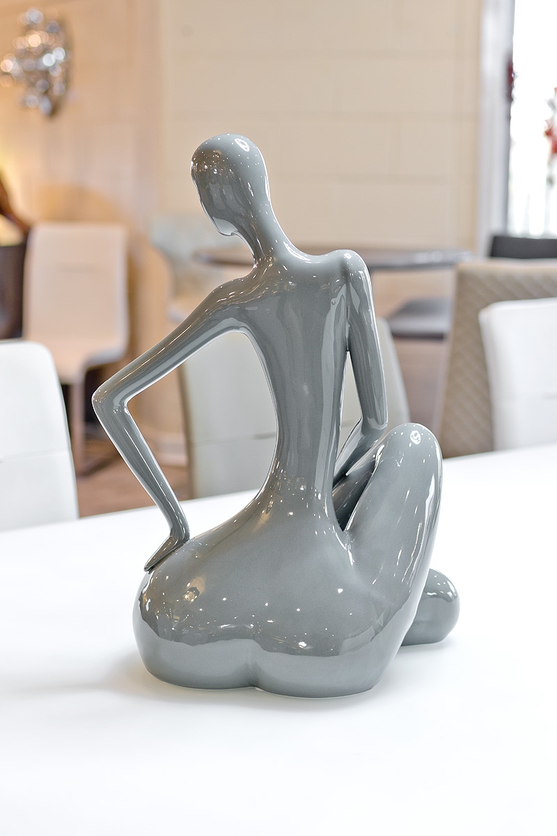 ceramic grey sitting lady in our showroom from the back