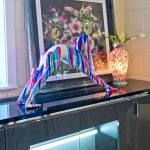 Pink and blue yoga lady sculpture in our showroom