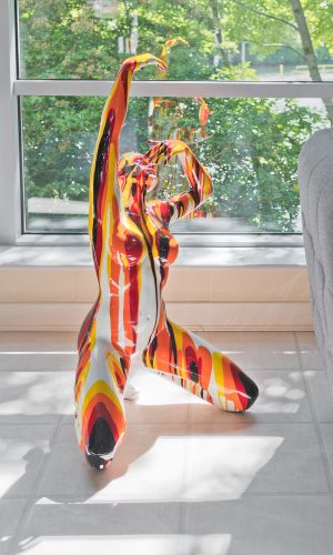 Large Red and Yellow Yoga Lady Sculpture in our Showroom