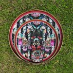 Myrtle and Mary Paradise Lost Circular Trays on Display in the Garden