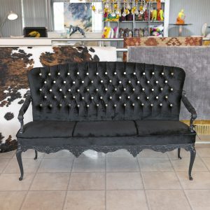 Black velvet love seat in our showroom